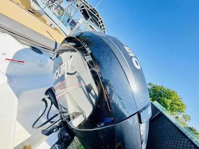 Slide: The Image of 2019 Sea Ray SPX 210 with Mercury outboard engine, docked under clear blue sky. - 3