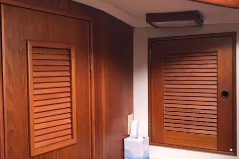 Slide: The Image of Interior of 1988 Nonsuch 33 sailboat with wooden louvered cabinets. - 19