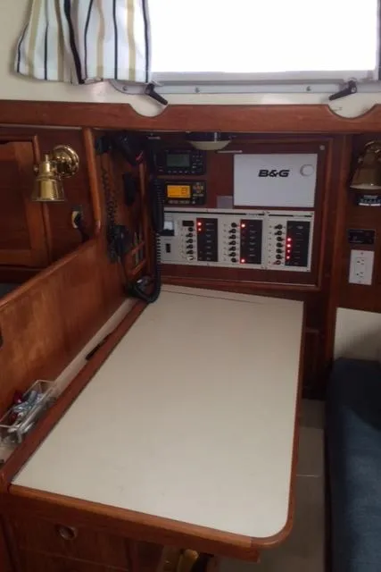 Slide: The Image of Navigation station on a 1988 Nonsuch 33 sailboat with control panels and equipment. - 21