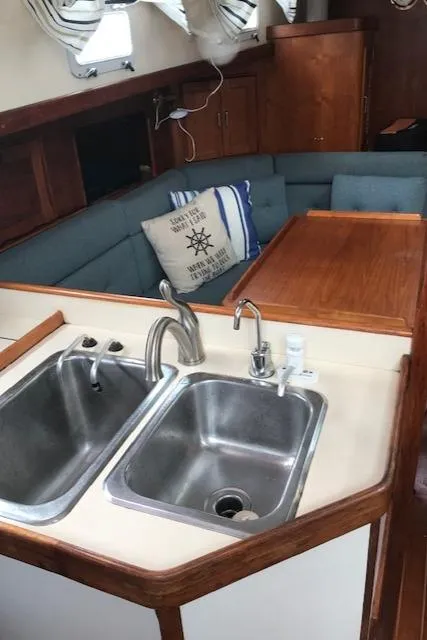 Slide: The Image of 1988 Nonsuch 33 yacht interior with dual sinks and cozy seating area. - 24