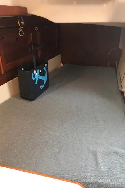 Slide: The Image of Interior cabin of 1988 Nonsuch 33 sailboat with anchor-themed bag. - 32