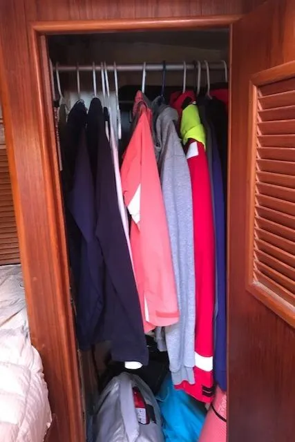 Slide: The Image of Closet with assorted clothing in a 1988 Nonsuch 33 sailboat interior. - 33