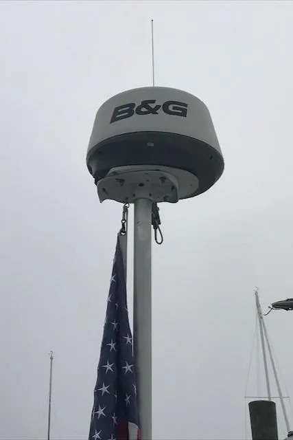 Slide: The Image of Radar equipment on a 1988 Nonsuch 33 sailboat with an American flag. - 9