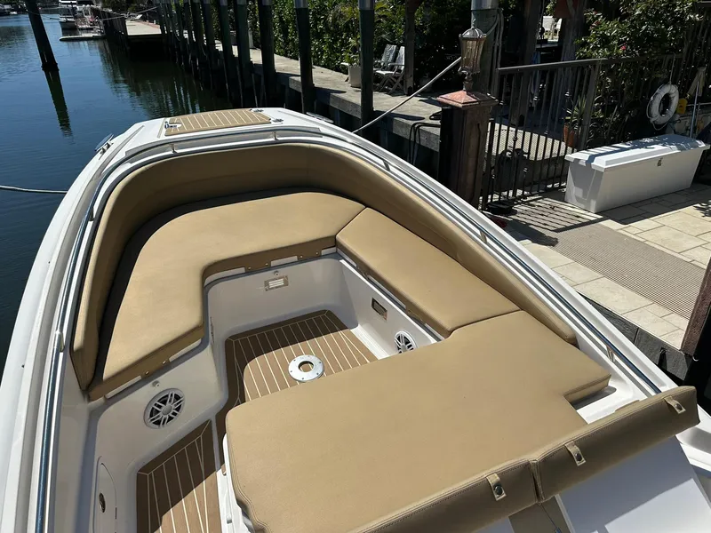 Slide: The Image of 2022 Zar Formenti 95 SL boat with tan seating and wood accents docked by the water. - 10