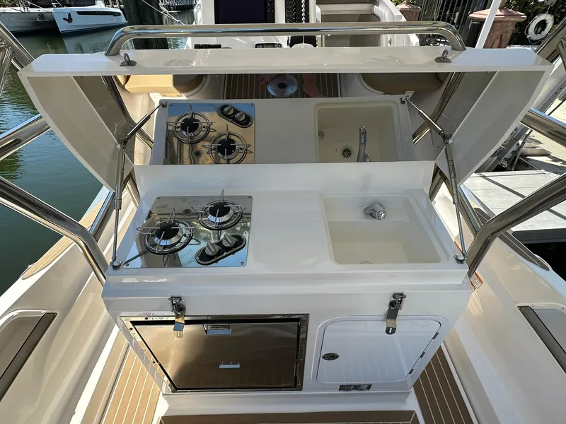 Slide: The Image of Outdoor kitchen on 2022 Zar Formenti 95 SL boat with stove, sink, and storage. - 12