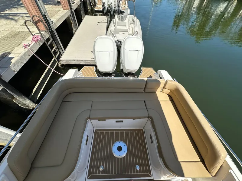 Slide: The Image of 2022 Zar Formenti 95 SL boat with spacious seating and dual engines at a dock. - 15