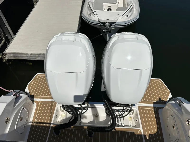 Slide: The Image of Twin outboard engines on a 2022 Zar Formenti 95 SL boat at a dock. - 16