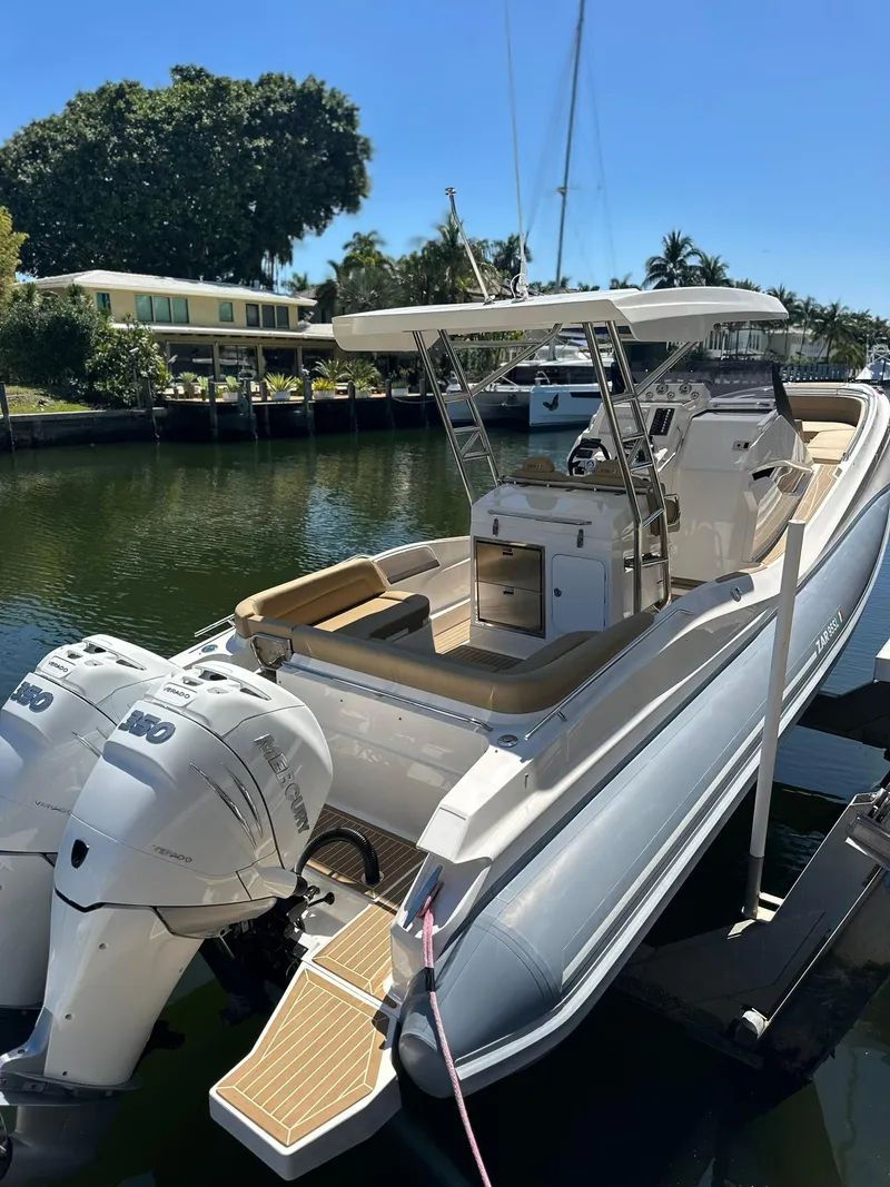 Slide: The Image of 2022 Zar Formenti 95 SL boat docked, featuring dual outboard engines and sleek design. - 22