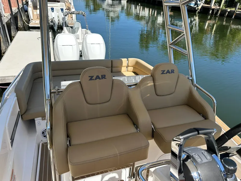 Slide: The Image of 2022 Zar Formenti 95 SL boat with tan seats, dual engines, and sleek design. - 3
