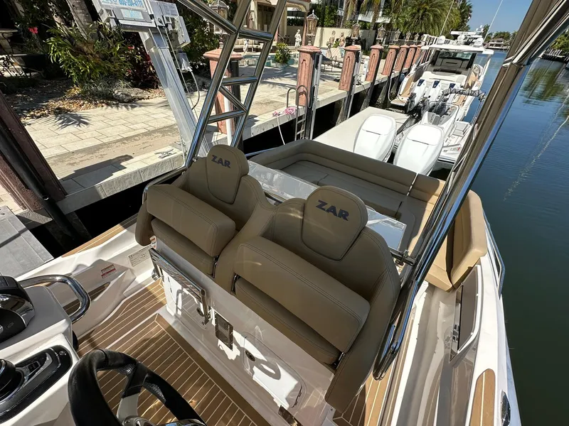 Slide: The Image of 2022 Zar Formenti 95 SL boat interior with dual seats at a marina. - 4