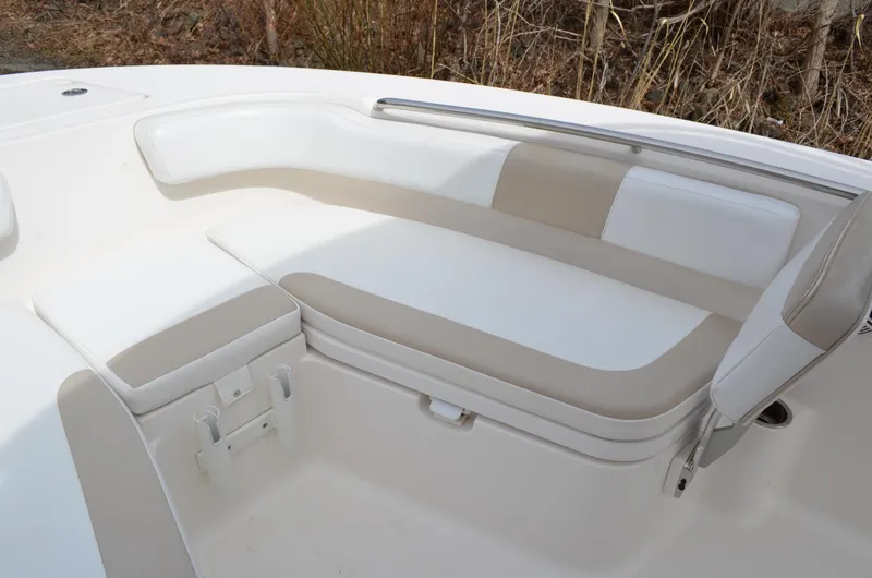 Slide: The Image of 2018 Robalo R200 Center Console boat seating area with cushioned bench and storage. - 12