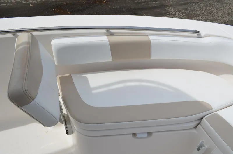 Slide: The Image of 2018 Robalo R200 Center Console boat seating area with beige and white cushions. - 13