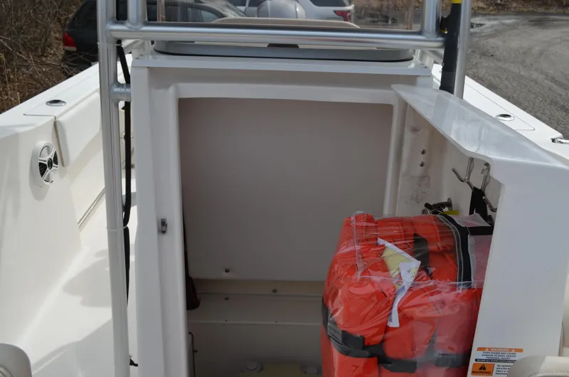 Slide: The Image of 2018 Robalo R200 Center Console storage compartment with life jackets. - 17