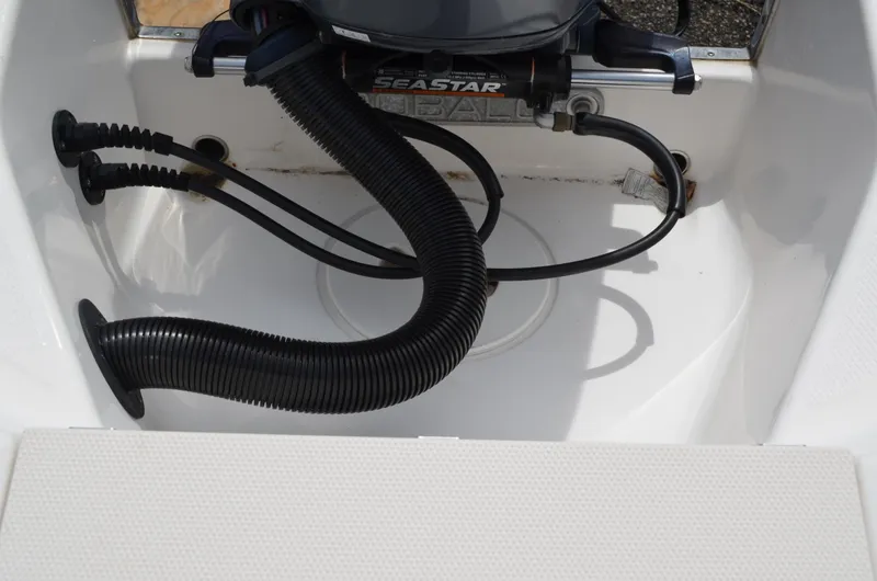 Slide: The Image of 2018 Robalo R200 Center Console boat engine compartment with hoses and cables. - 24