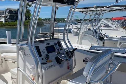 Slide: The Image of 2018 Robalo R200 Center Console boat docked, featuring steering console and seating. - 32