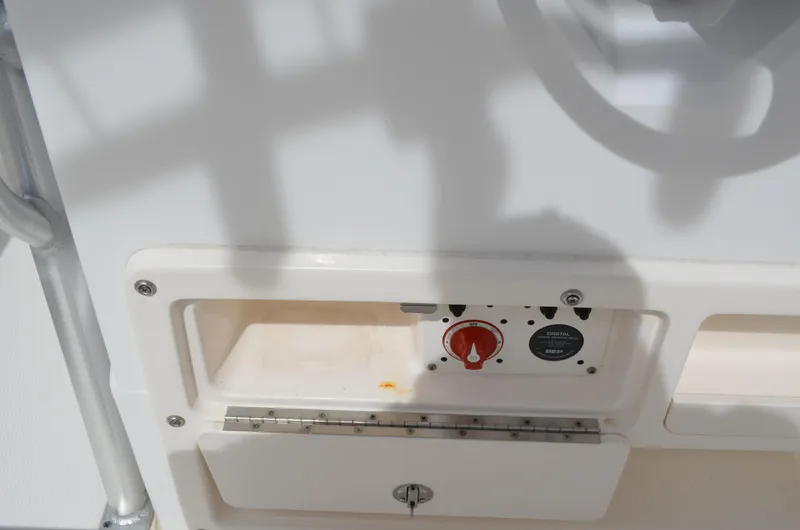 Slide: The Image of 2018 Robalo R200 Center Console boat dashboard with control panel and storage compartment. - 33