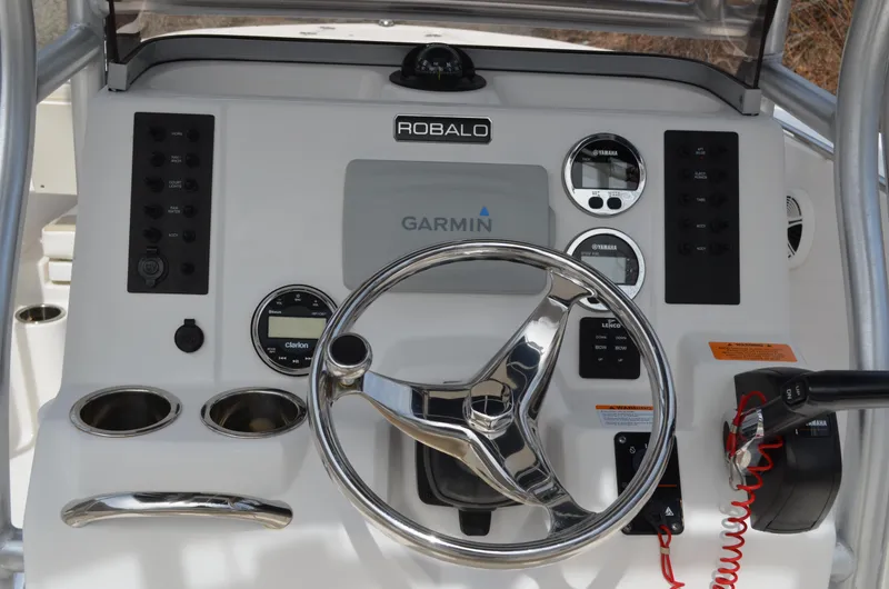 Slide: The Image of 2018 Robalo R200 Center Console dashboard with Garmin navigation system and steering wheel. - 34