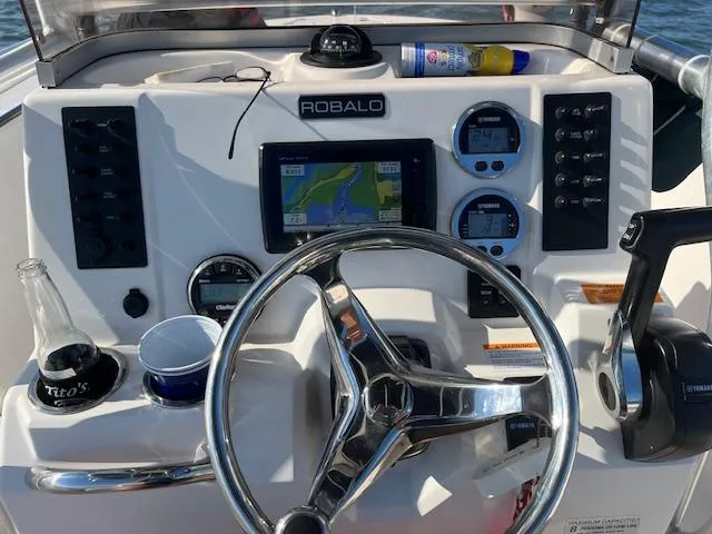 Slide: The Image of 2018 Robalo R200 Center Console dashboard with steering wheel and navigation system. - 35