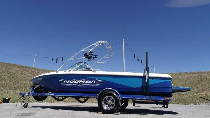 Slide: The Image of 2009 Moomba Outback SK boat on trailer under clear blue sky. - 10