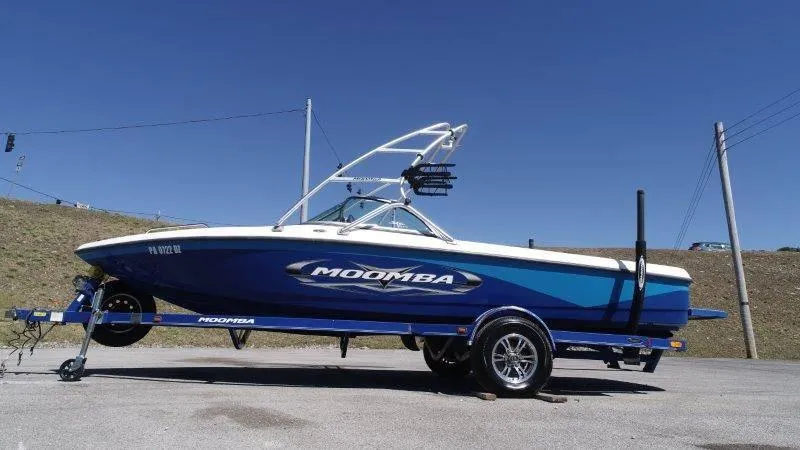 Slide: The Image of 2009 Moomba Outback SK boat on trailer under clear blue sky. - 11