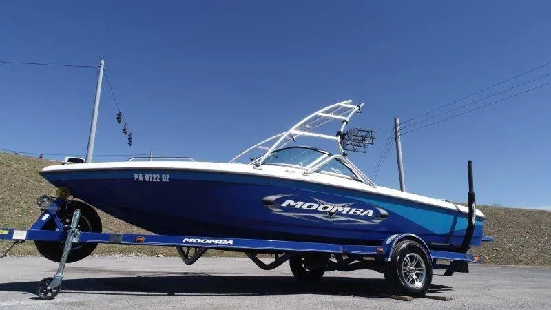 Slide: The Image of 2009 Moomba Outback SK boat on trailer under clear blue sky. - 14