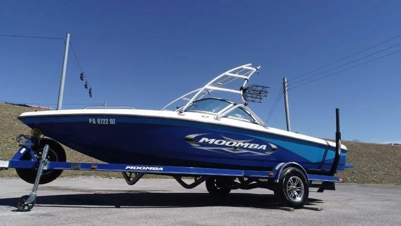 Slide: The Image of 2009 Moomba Outback SK boat on trailer under clear blue sky. - 15