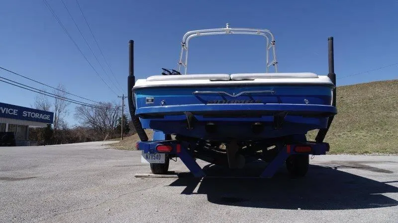 Slide: The Image of 2009 Moomba Outback SK boat on trailer, rear view, parked outdoors. - 16