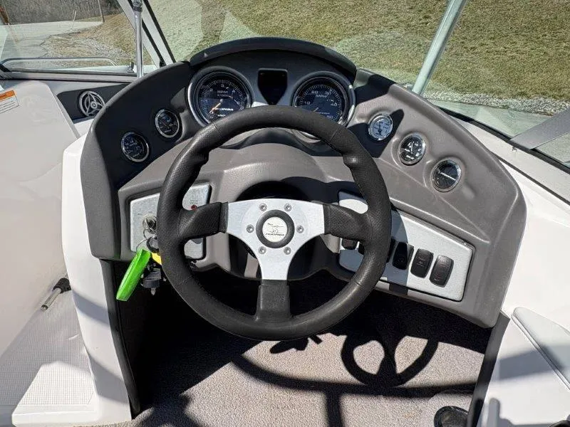 Slide: The Image of 2009 Moomba Outback SK boat dashboard with steering wheel and gauges. - 29