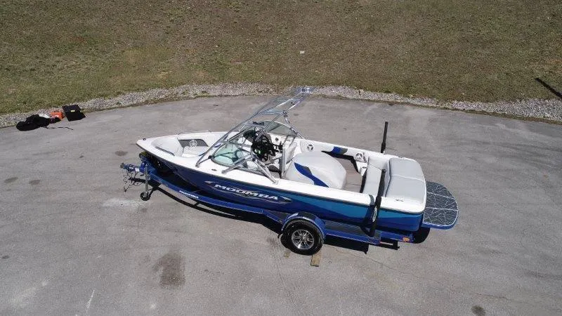 Slide: The Image of 2009 Moomba Outback SK boat on trailer, parked on pavement, aerial view. - 3