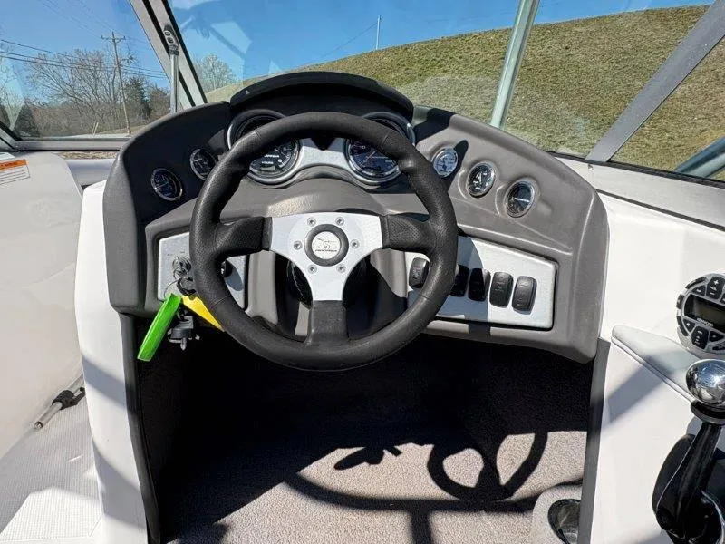Slide: The Image of 2009 Moomba Outback SK boat dashboard with steering wheel and gauges. - 32