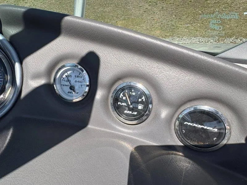 Slide: The Image of Dashboard gauges of a 2009 Moomba Outback SK boat, showing temperature and fuel levels. - 34