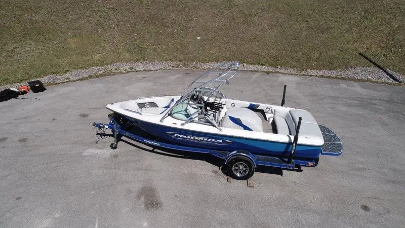 Slide: The Image of 2009 Moomba Outback SK boat on trailer, parked on paved surface. - 4
