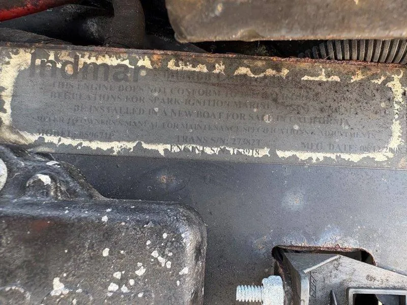 Slide: The Image of Close-up of a 2009 Moomba Outback SK engine label with worn text. - 47