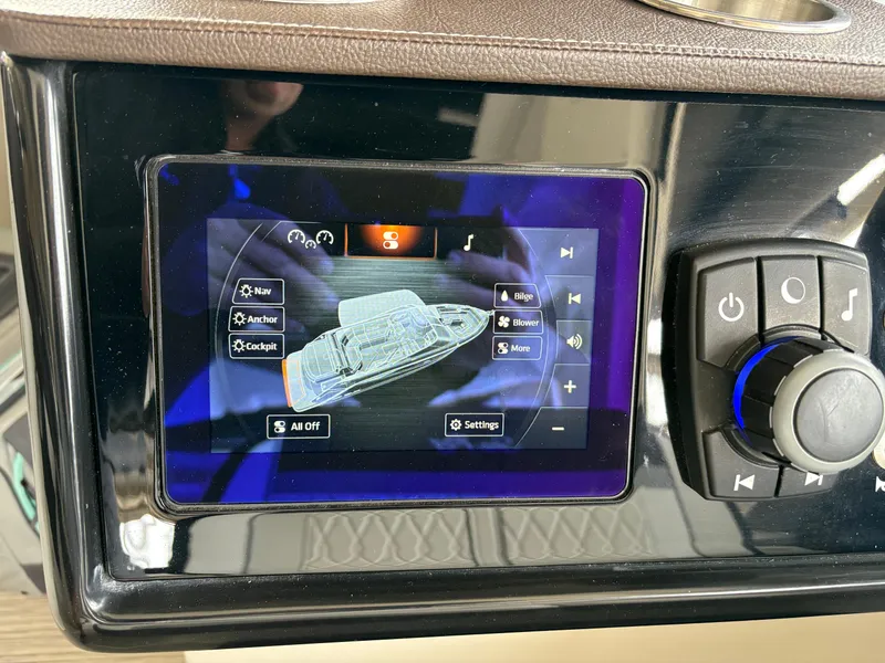 Slide: The Image of 2017 Sea Ray SLX 310 control panel with touchscreen and navigation buttons. - 11