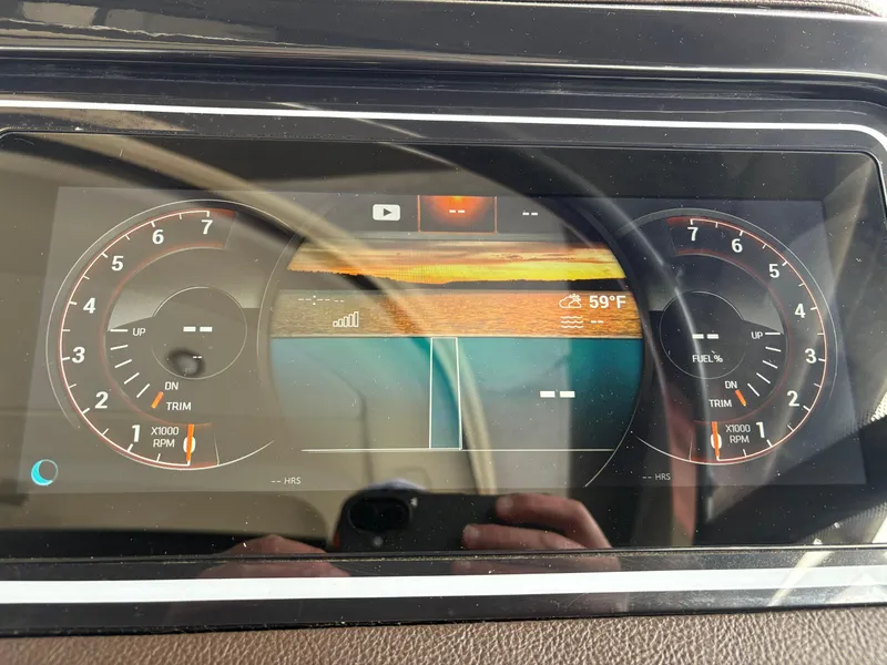 Slide: The Image of Dashboard of a 2017 Sea Ray SLX 310 boat showing gauges and digital display. - 17