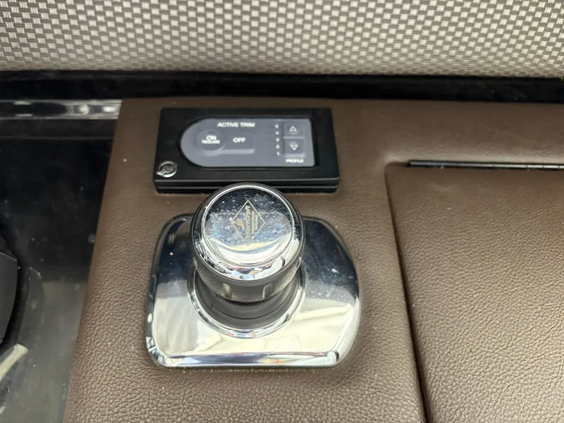 Slide: The Image of 2017 Sea Ray SLX 310 boat control panel with joystick and trim settings. - 19