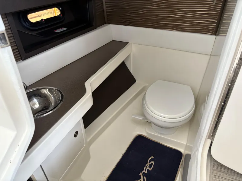 Slide: The Image of 2017 Sea Ray SLX 310 boat bathroom with sink and toilet. - 23