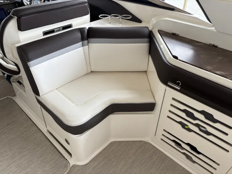 Slide: The Image of Luxurious seating area on a 2017 Sea Ray SLX 310 boat, featuring elegant upholstery. - 28