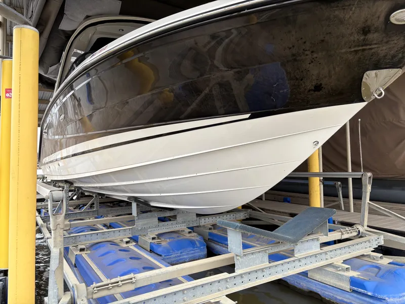 Slide: The Image of 2017 Sea Ray SLX 310 boat on a lift, showcasing sleek hull design. - 3