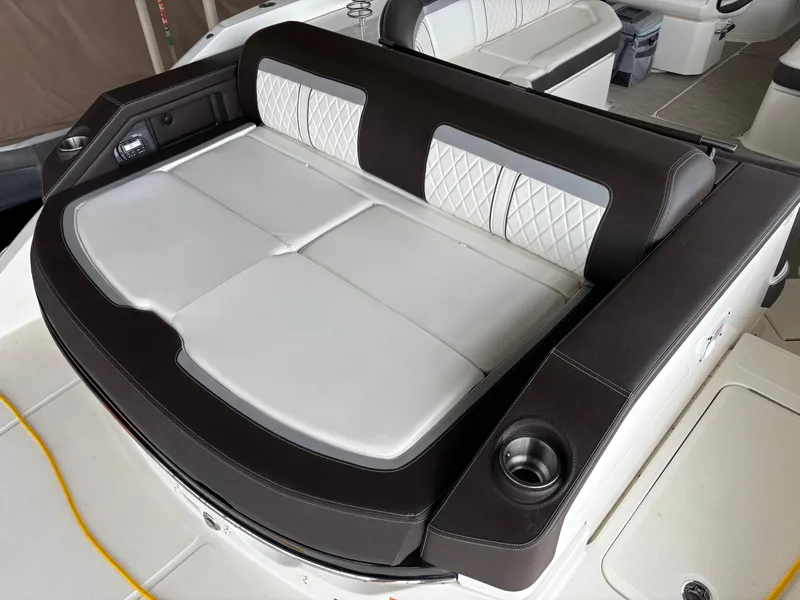 Slide: The Image of 2017 Sea Ray SLX 310 boat interior with cushioned seating and cup holders. - 30