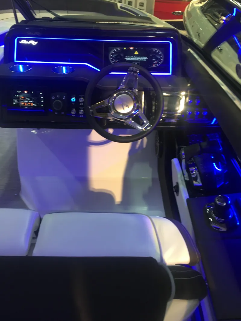 Slide: The Image of 2017 Sea Ray SLX 310 cockpit with illuminated dashboard and steering wheel. - 33