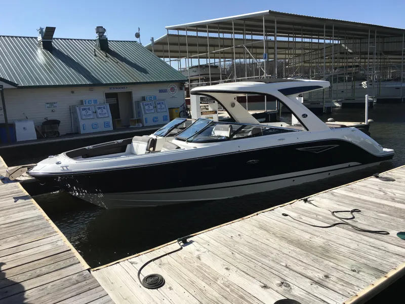 Slide: The Image of 2017 Sea Ray SLX 310 boat docked at a marina under sunny skies. - 36