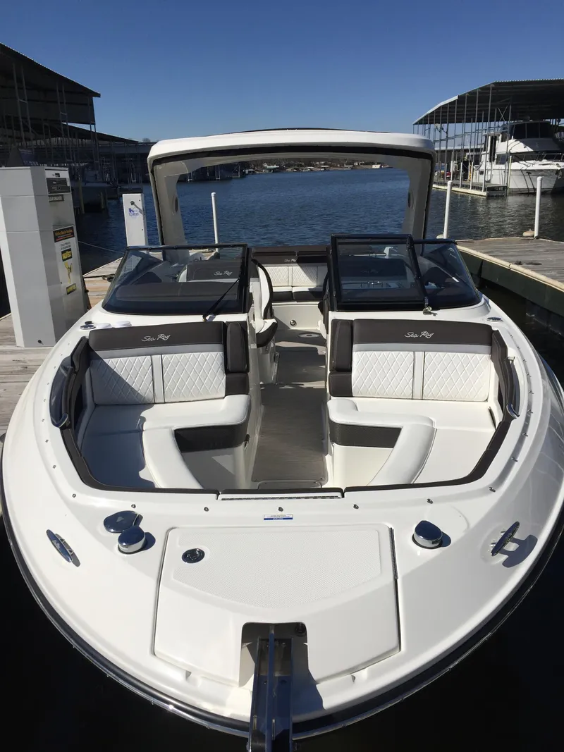 Slide: The Image of 2017 Sea Ray SLX 310 boat docked, featuring spacious seating and sleek design. - 37