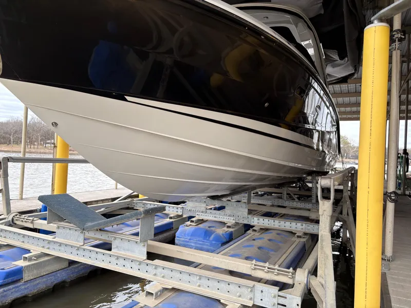 Slide: The Image of 2017 Sea Ray SLX 310 boat on a lift at a dockside location. - 4