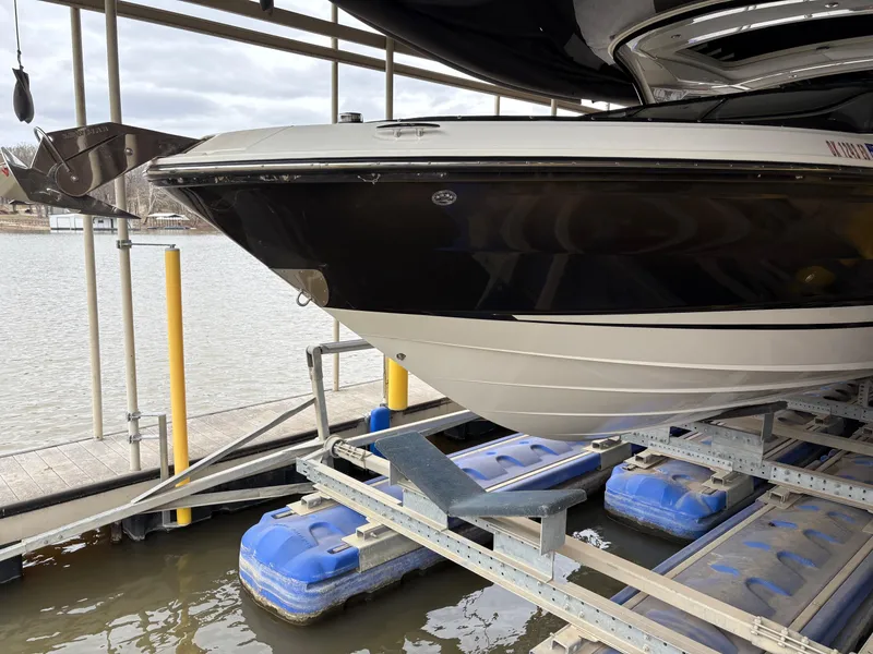 Slide: The Image of 2017 Sea Ray SLX 310 boat on a lift at a marina dock. - 5
