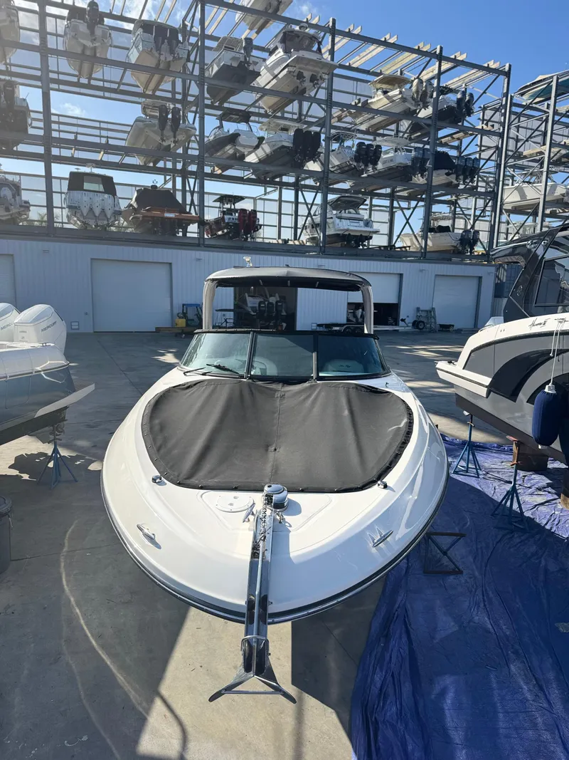 Slide: The Image of 2014 Sea Ray 300 SLX boat in storage facility, front view. - 11