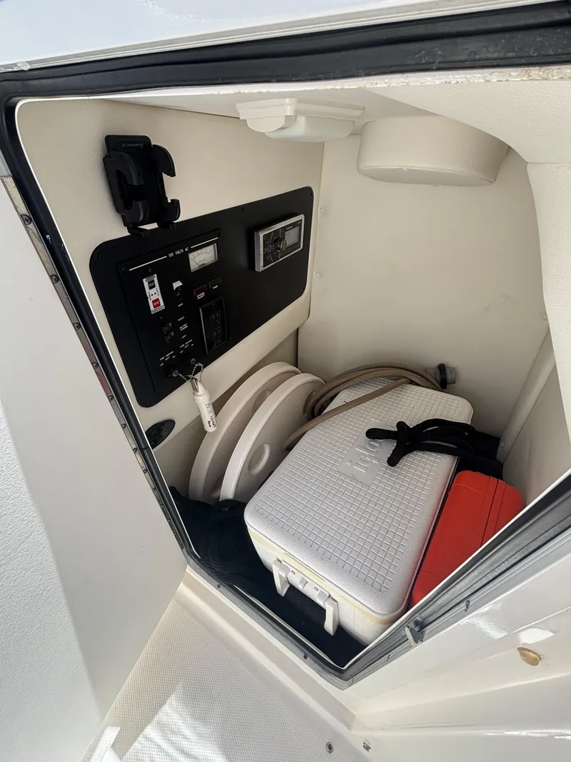 Slide: The Image of Interior storage compartment of 2014 Sea Ray 300 SLX boat with cooler and equipment. - 12