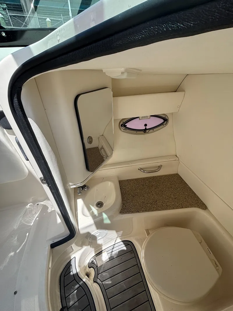 Slide: The Image of Interior cabin of 2014 Sea Ray 300 SLX boat with porthole and seating area. - 14