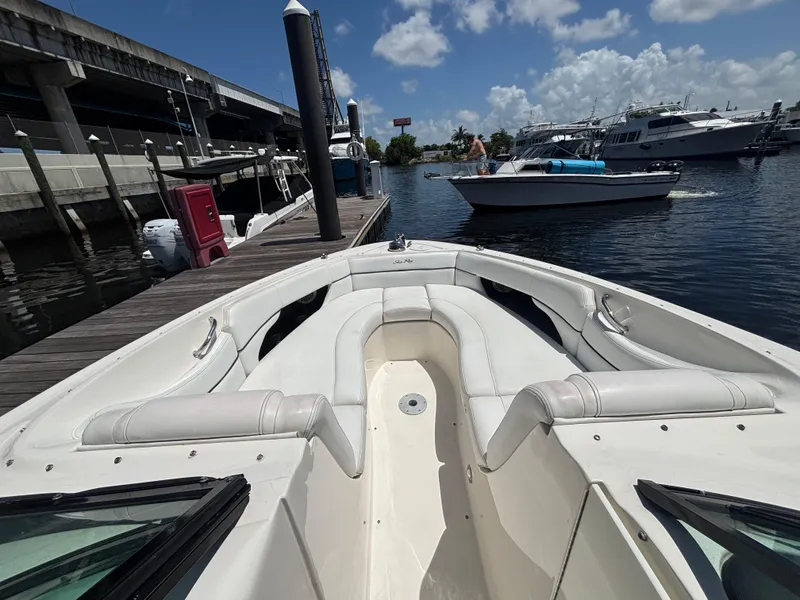 Slide: The Image of 2014 Sea Ray 300 SLX boat docked, featuring spacious seating and sleek design. - 2