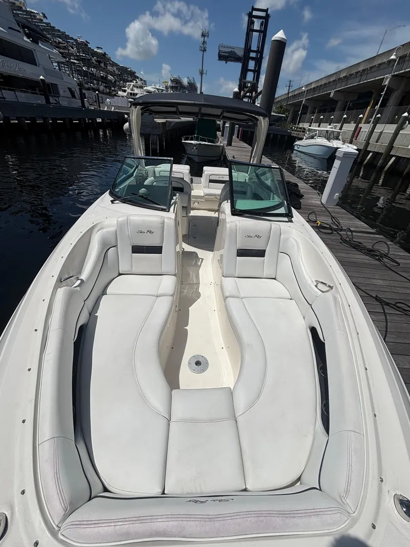 Slide: The Image of 2014 Sea Ray 300 SLX boat docked, featuring spacious seating and sleek design. - 4